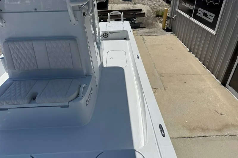Slide: The Image of 2026 Shallow Sport 25 X3 boat deck with seating and storage compartments. - 24