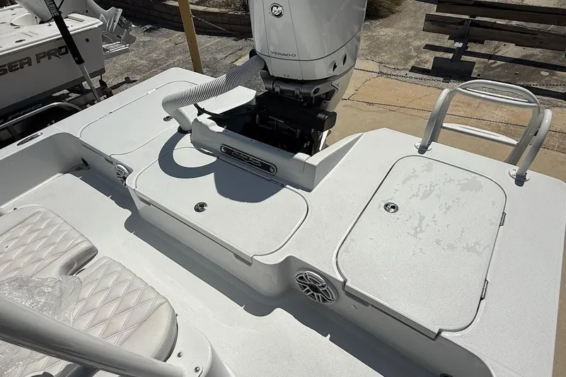 Slide: The Image of 2026 Shallow Sport 25 X3 boat deck with engine and seating. - 26