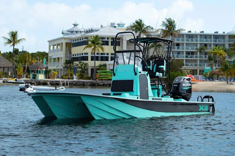 Slide: The Image of Manufacturer Provided Image: 2025 Shallow Sport 25 X3 boat on water near tropical resort buildings. - 5