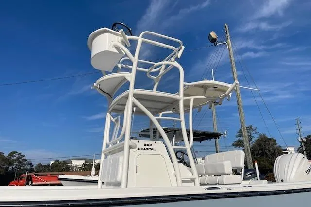Slide: The Image of Parker 230 Coastal Elite 2026 with elevated helm against blue sky. - 2