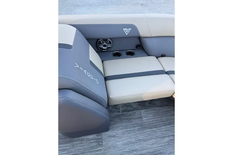 Slide: The Image of 2026 Viaggio x22u boat interior with beige and gray seating, cup holders, and speaker. - 26