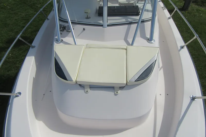 Slide: The Image of 1996 Grady-White Voyager 248 boat deck with cushioned seating and railing. - 10