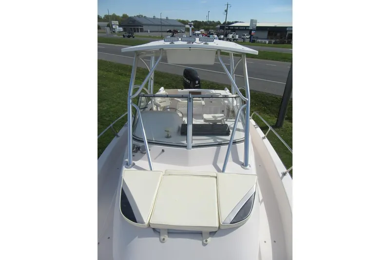 Slide: The Image of 1996 Grady-White Voyager 248 boat with T-top and seating, parked near a road. - 11