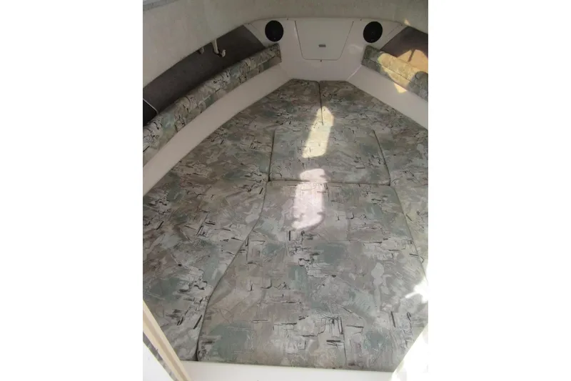 Slide: The Image of 1996 Grady-White Voyager 248 cabin interior with patterned cushions and compact design. - 15