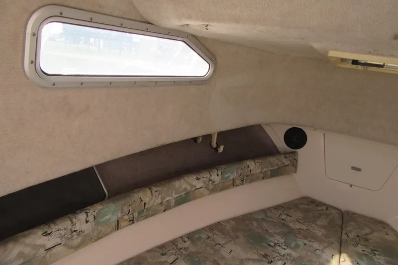 Slide: The Image of Interior cabin of 1996 Grady-White Voyager 248 boat with window and seating area. - 18