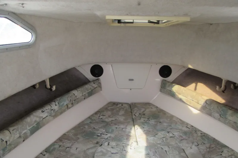 Slide: The Image of Interior cabin of 1996 Grady-White Voyager 248 boat with cushioned seating. - 19
