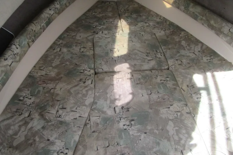 Slide: The Image of Interior cabin of 1996 Grady-White Voyager 248 with patterned cushions. - 22