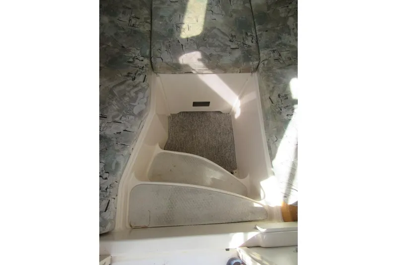 Slide: The Image of Interior cabin view of a 1996 Grady-White Voyager 248 boat, featuring seating and flooring. - 23