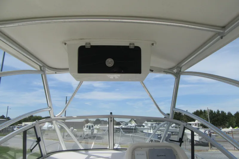 Slide: The Image of 1996 Grady-White Voyager 248 boat interior with overhead storage and clear windshield view. - 26