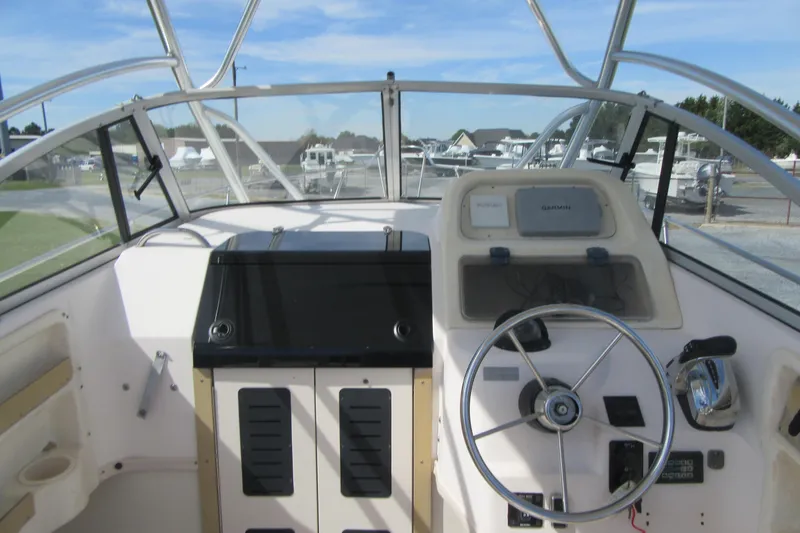 Slide: The Image of 1996 Grady-White Voyager 248 boat cockpit with steering wheel and navigation equipment. - 27
