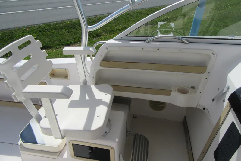 Slide: The Image of 1996 Grady-White Voyager 248 boat interior with seating and storage compartments. - 28