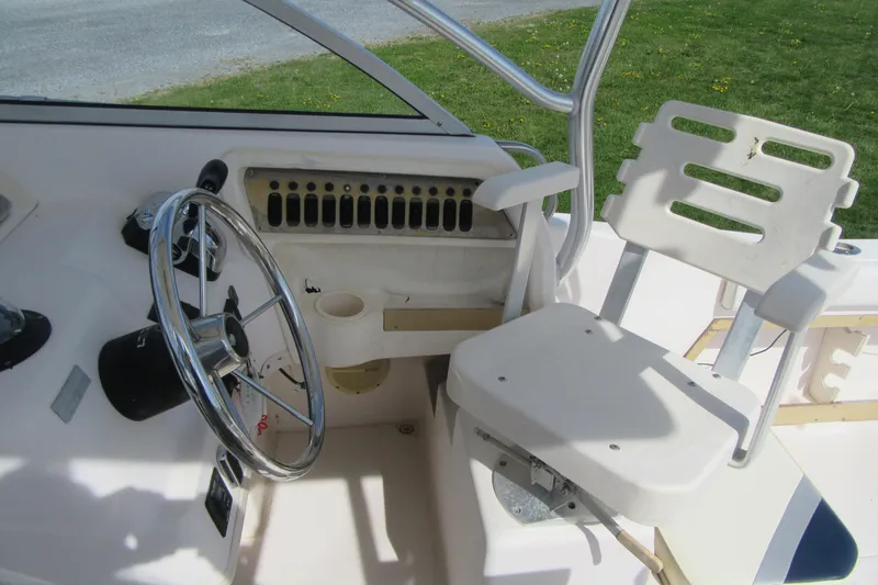 Slide: The Image of 1996 Grady-White Voyager 248 boat cockpit with steering wheel and captain's chair. - 29