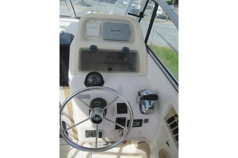 Slide: The Image of 1996 Grady-White Voyager 248 boat helm with steering wheel and navigation equipment. - 30