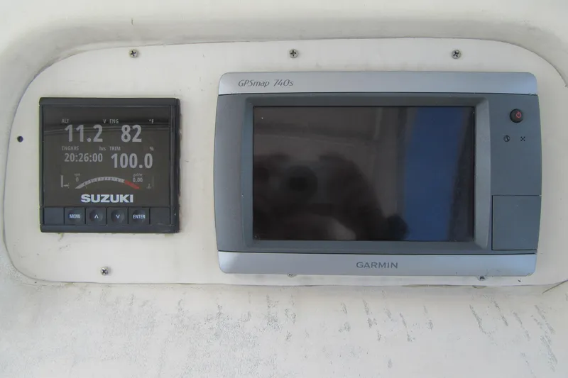 Slide: The Image of Suzuki and Garmin displays on 1996 Grady-White Voyager 248 boat dashboard. - 31