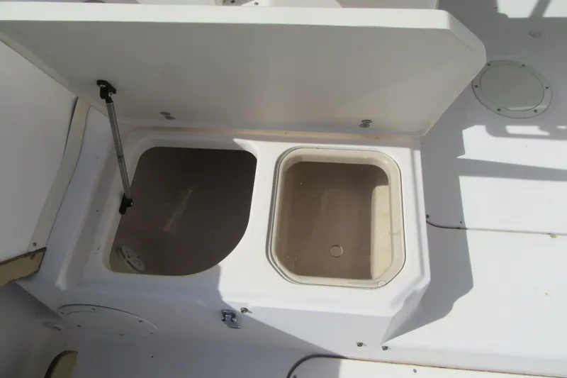 Slide: The Image of Open storage compartments on a 1996 Grady-White Voyager 248 boat deck. - 33