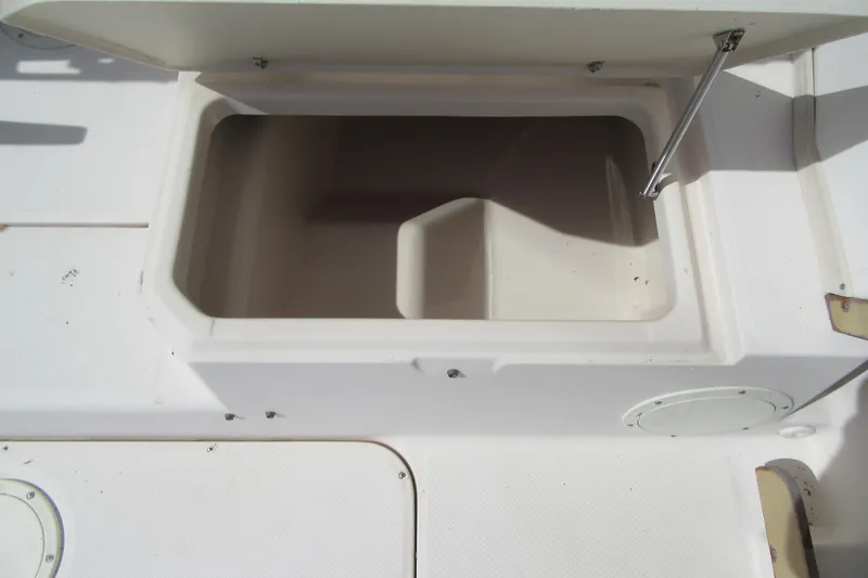 Slide: The Image of Open storage compartment on a 1996 Grady-White Voyager 248 boat deck. - 34