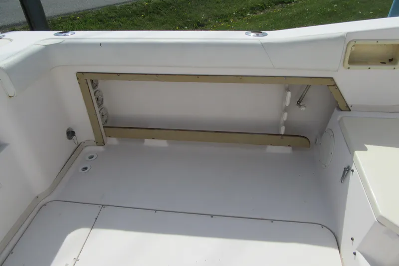 Slide: The Image of 1996 Grady-White Voyager 248 boat interior, featuring spacious seating and storage area. - 36