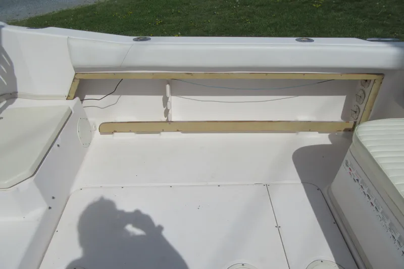 Slide: The Image of 1996 Grady-White Voyager 248 boat interior with seating and storage area. - 37