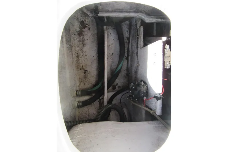 Slide: The Image of Interior view of a 1996 Grady-White Voyager 248 boat, showing hoses and mechanical components. - 44