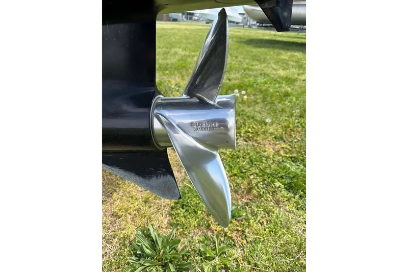 Slide: The Image of Close-up of a shiny boat propeller on a 1996 Grady-White Voyager 248. - 45