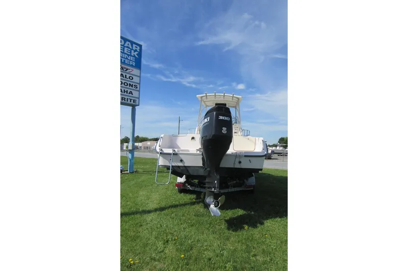 Slide: The Image of 1996 Grady-White Voyager 248 boat with Suzuki 300 engine on grassy area. - 6