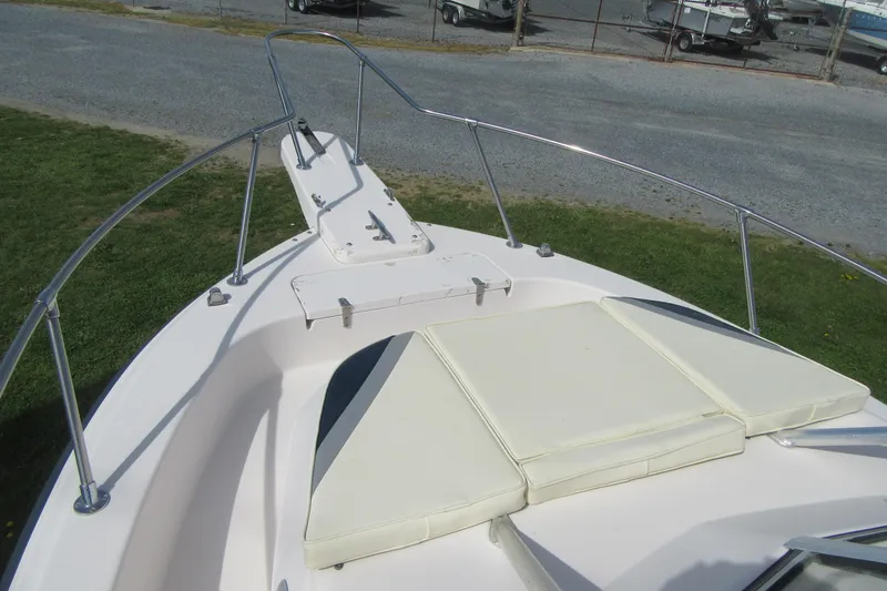 Slide: The Image of 1996 Grady-White Voyager 248 boat bow with cushioned seating and stainless steel railings. - 7