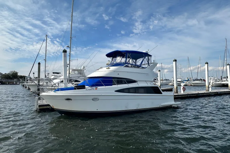 The Image of 2005 Carver 36 Super Sport yacht docked at marina under blue sky. - 0