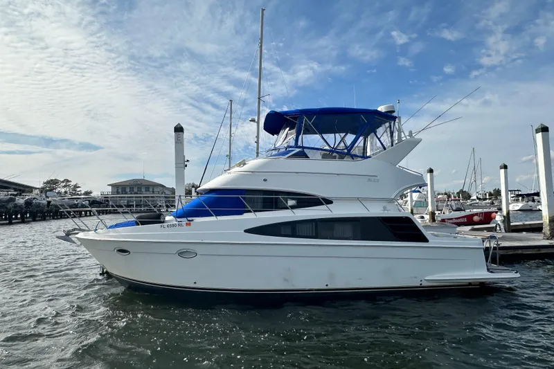 Slide: The Image of 2005 Carver 36 Super Sport yacht docked at marina under blue sky. - 1