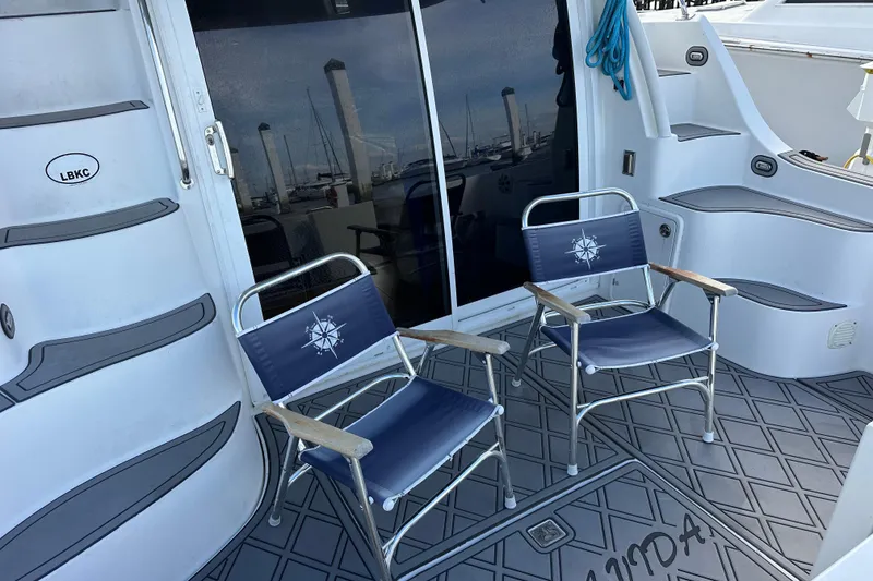 Slide: The Image of 2005 Carver 36 Super Sport yacht deck with two nautical-themed chairs. - 14