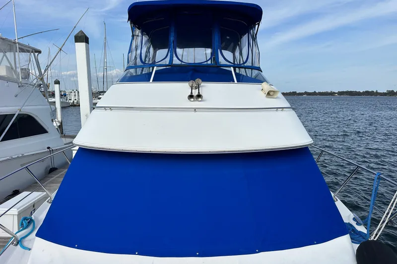 Slide: The Image of 2005 Carver 36 Super Sport yacht with blue and white exterior docked at marina. - 16
