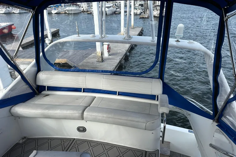 Slide: The Image of 2005 Carver 36 Super Sport yacht interior with seating, docked at marina. - 18