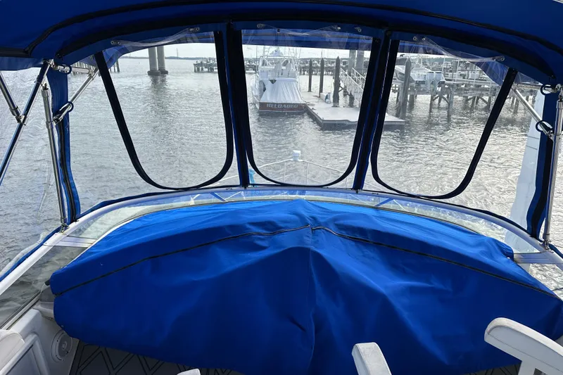 Slide: The Image of 2005 Carver 36 Super Sport boat interior with blue cover, docked at marina. - 19
