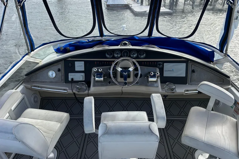 Slide: The Image of 2005 Carver 36 Super Sport helm with steering wheel, controls, and seating. - 20