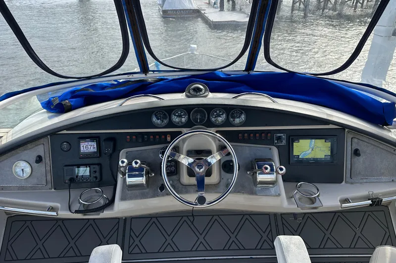 Slide: The Image of 2005 Carver 36 Super Sport yacht helm with navigation instruments and steering wheel. - 21
