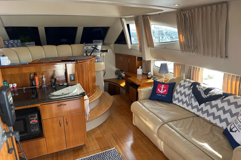 Slide: The Image of Luxurious interior of 2005 Carver 36 Super Sport yacht with elegant seating and kitchenette. - 23