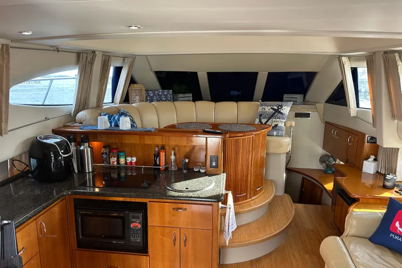 Slide: The Image of Interior of 2005 Carver 36 Super Sport yacht with modern kitchen and seating area. - 24