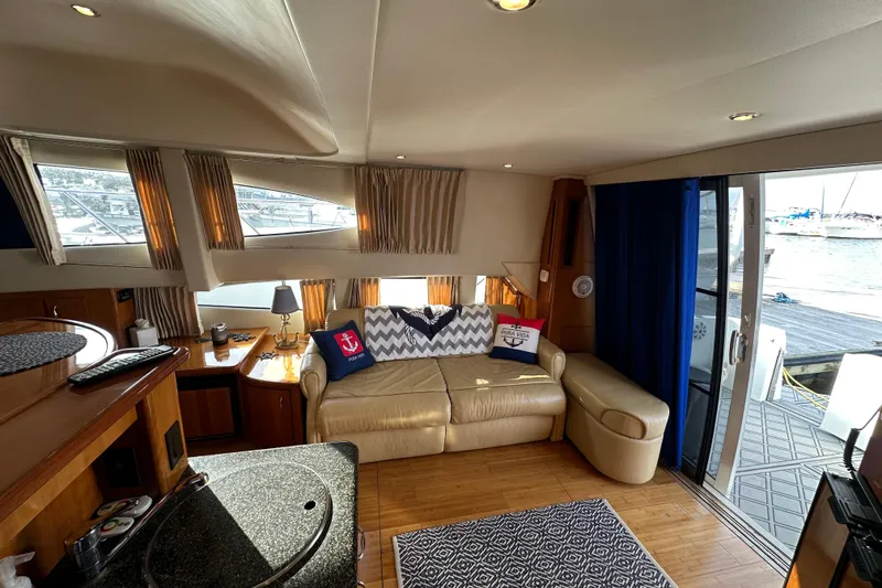 Slide: The Image of Interior of 2005 Carver 36 Super Sport yacht with cozy seating and nautical decor. - 25