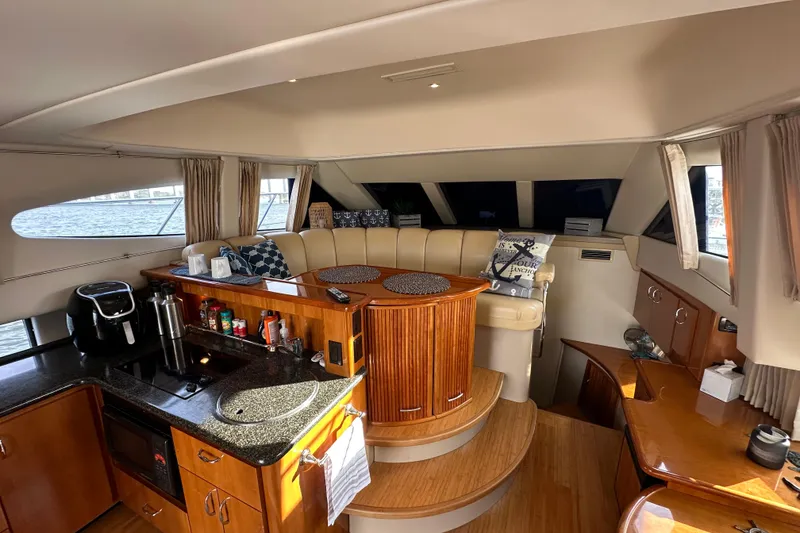 Slide: The Image of Luxurious interior of 2005 Carver 36 Super Sport yacht with modern kitchen and seating area. - 27