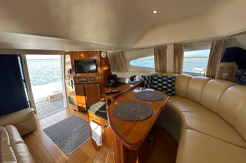 Slide: The Image of Luxurious interior of 2005 Carver 36 Super Sport yacht with elegant seating and wood finishes. - 28