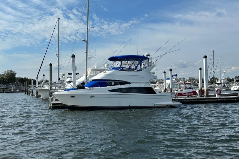 Slide: The Image of 2005 Carver 36 Super Sport yacht docked at marina under blue sky. - 3