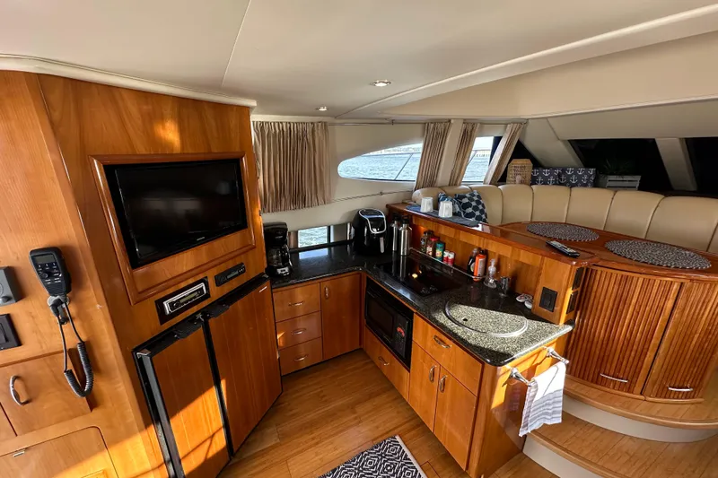 Slide: The Image of Interior of 2005 Carver 36 Super Sport yacht with modern kitchen and seating area. - 30