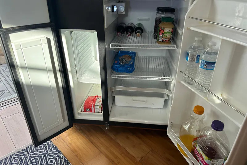 Slide: The Image of Open refrigerator in a 2005 Carver 36 Super Sport, stocked with drinks and snacks. - 31