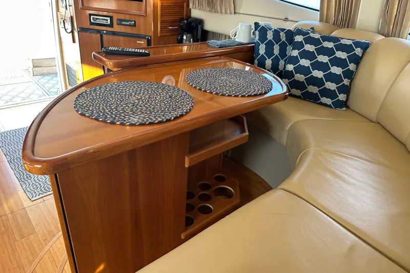 Slide: The Image of Interior of 2005 Carver 36 Super Sport yacht with wooden table and cushioned seating. - 32