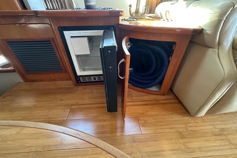 Slide: The Image of 2005 Carver 36 Super Sport interior with open storage compartments and wooden flooring. - 34