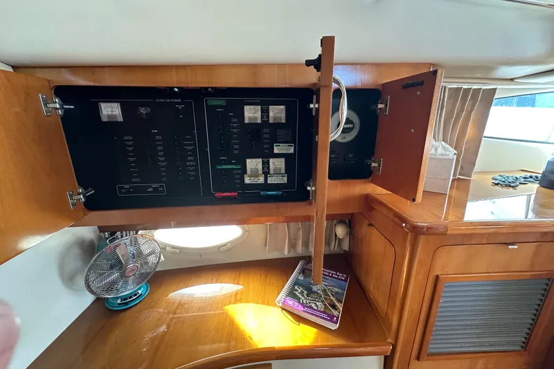 Slide: The Image of 2005 Carver 36 Super Sport interior with electrical panel and wooden cabinetry. - 35