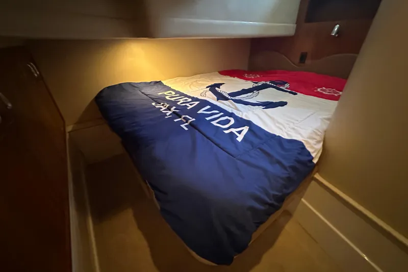 Slide: The Image of Cozy cabin interior of 2005 Carver 36 Super Sport with nautical-themed bedding. - 46