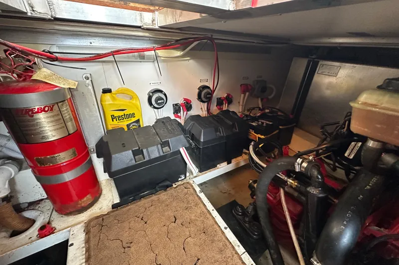 Slide: The Image of Engine room of 2005 Carver 36 Super Sport with fire extinguisher and Prestone antifreeze. - 50