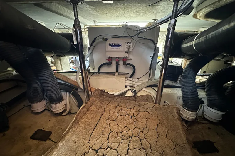 Slide: The Image of Engine room of 2005 Carver 36 Super Sport with visible hoses and equipment. - 55