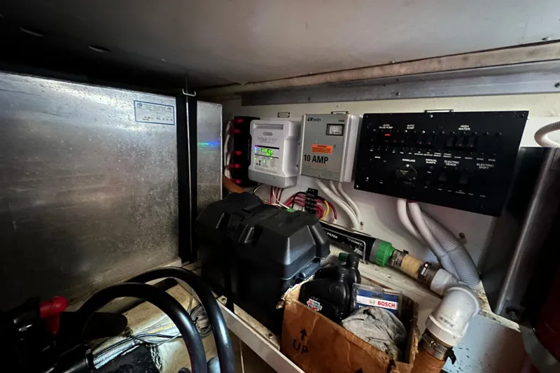 Slide: The Image of Electrical panel and components inside a 2005 Carver 36 Super Sport boat. - 56