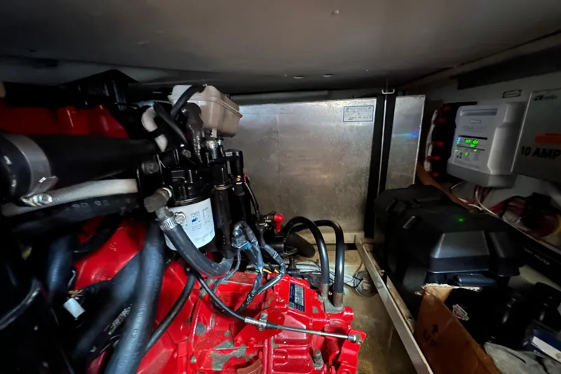 Slide: The Image of Engine room of 2005 Carver 36 Super Sport, showcasing mechanical components and wiring. - 57